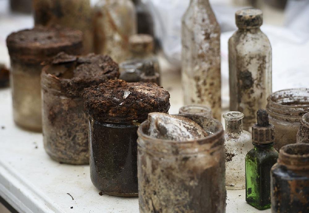 Jars and bottles excavated from a trash pit in the backyard of the Crescent Hotel in Eureka Springs await further attention Thursday.