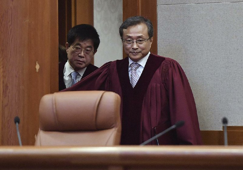 South Korea’s Constitutional Court chief judge Yoo Nam-seok (right) arrives Thursday for the ruling on decriminalization of abortion in Seoul. 