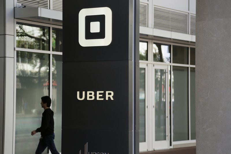 In this June 21, 2017, file photo a man walks into the building that houses the headquarters of Uber in San Francisco. Documents released Thursday, April 11, 2019, offered the most detailed view of the world's largest ride-hailing service since its inception a decade ago. (AP Photo/Eric Risberg, File)