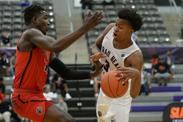 Moses Moody dribbles around a defender during an AAU game Friday, April 12, 2019, at Bulldog Arena in Fayetteville.