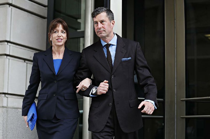 W. Samuel Patten (right), with his wife, leaves federal court Friday in Washington after being sentenced to three years of probation in the Trump Russia probe case. 