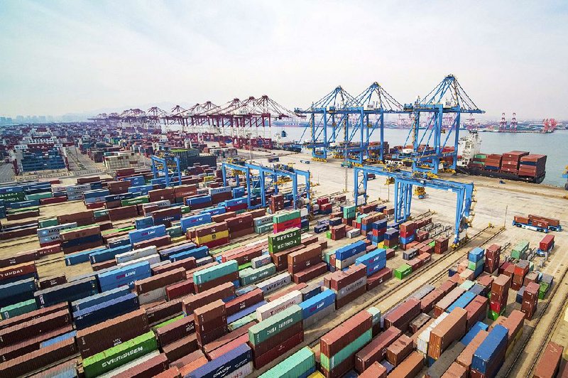 Containers are stacked at a port in Qingdao, China, in March. China’s exports jumped 14.2 percent in March from a year earlier while imports fell 7.6 percent, customs data showed said Friday. 