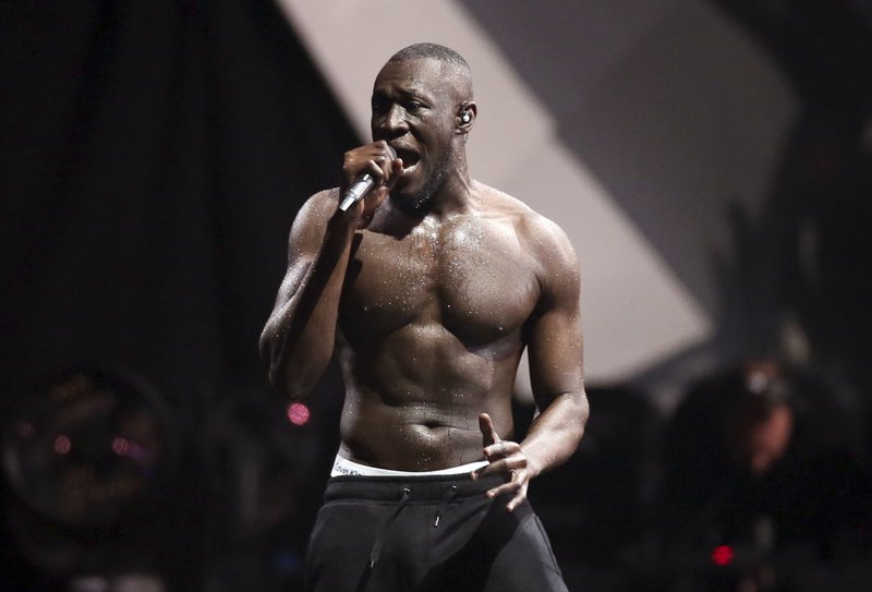 FILE - In this file photo dated Wednesday, Feb. 21, 2018, British grime artist Stormzy performs at the Brit Awards 2018 in London. The Austrian music Snowbombing festival in Mayrhofen, Austria, is apologizing to Stormzy, who pulled out of an appearance on Wednesday April 10, 2019, after accusing security staff of racial profiling. (Photo by Joel C Ryan/Invision/AP, file)