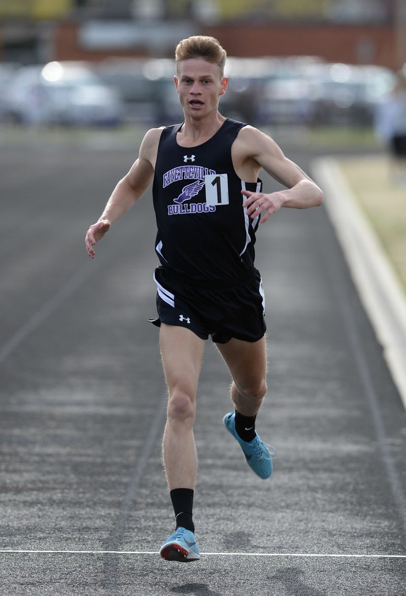 NWA Democrat-Gazette/ANDY SHUPE Fayetteville's Camren Fischer comes in at the finish line Friday, April 12, 2019, to win the 1,600 meters during the Bulldog Relays at Ramay Junior High School in Fayetteville. Visit nwadg.com/photos to see more photographs from the meet.