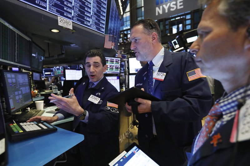 Specialist Peter Mazza, left, and trader Jonathan Corpina, center, work on the floor of the New York Stock Exchange, Friday, April 12, 2019. U.S. stocks moved broadly higher in early trading Friday on Wall Street, putting the market on track for gains at the end of a shaky week. (AP Photo/Richard Drew)