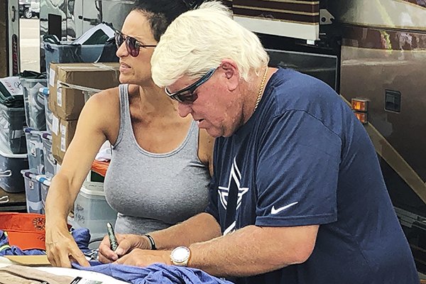 John Daly has signs autographs outside a Hooters on Washington Road during the third round for the Masters golf tournament Saturday, April 13, 2019, in Augusta, Ga. (AP Photo/Paul Newberry)
