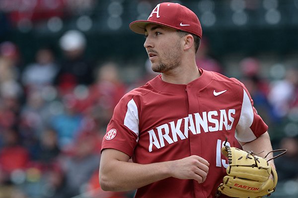 Arkansas starter Connor Noland backs up third as Ole Miss scores a run Saturday, March 30, 2019, on a single by third baseman Tyler Keenan during the third inning at Baum-Walker Stadium in Fayetteville.