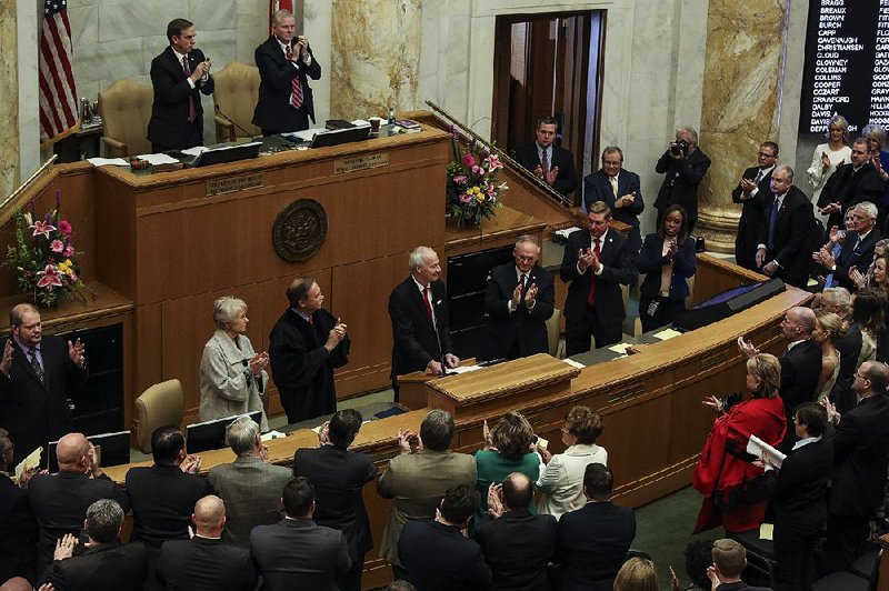 Lawmakers give Gov. Asa Hutchinson a standing ovation during his State of the State Address on Jan. 15, after he was sworn in for a second term. The ensuing legislative session saw six ethics bills presented, but only three became law.