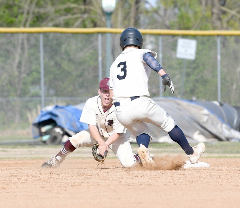 Bud Sullins/Special to Siloam Sunday Siloam Springs second baseman Isaac Price prepares to tag out Greenwood runner Peyton Holt on a stolen base attempt during Tuesday's game at James Butts Baseball Park.