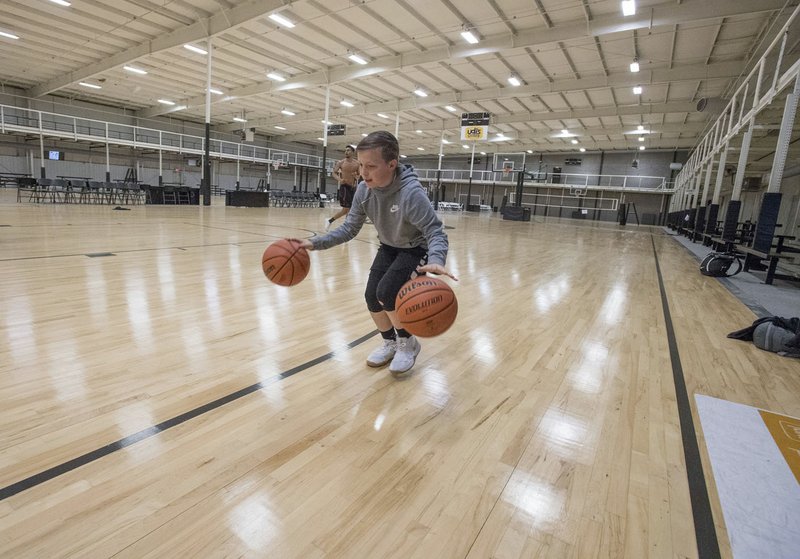 NWA Democrat-Gazette/J.T. WAMPLER Jackson Hallam, 11, warms up Thursday before a session with trainer Shannon Lang at the former All-Star Sports Arena in Springdale. The city purchased the athletic facility on Cambridge Street, formerly known as the All-Star Sports Arena and Next Level. It was part of a triple-decker real estate deal involving a business in downtown Springdale, the public schools and the city.