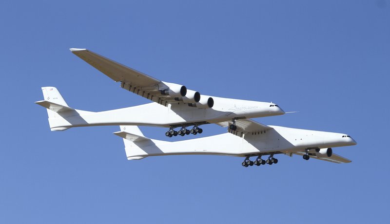 Stratolaunch, a giant six-engine aircraft with the world&#x2019;s longest wingspan , makes its historic first flight from the Mojave Air and Space Port in Mojave, Calif., Saturday, April 13, 2019. Founded by the late billionaire Paul G. Allen, Stratolaunch is vying to be a contender in the market for air-launching small satellites. (AP Photo/Matt Hartman)