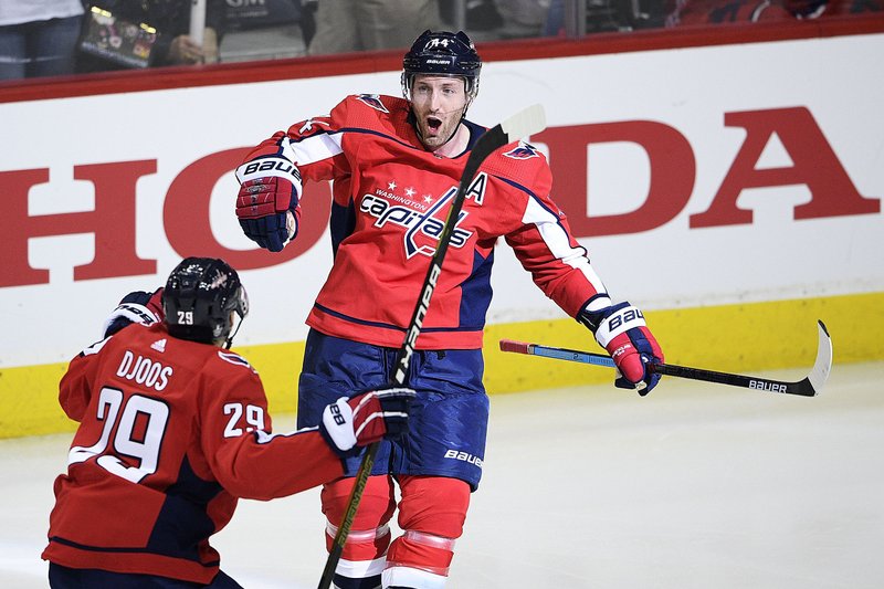 Washington Capitals defenseman Brooks Orpik celebrates his game-winning overtime goal with defenseman Christian Djoos during Game 2 of a first-round playoff series against the Carolina Hurricanes on Saturday in Washington. The Capitals won 4-3 to take a 2-0 series lead. 