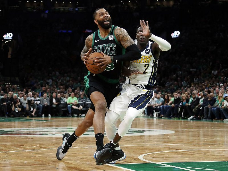 Boston’s Marcus Morris drives past Indiana’s Darren Collison during the second quarter in Game 1 of their first-round series Sunday in Boston. Morris had 20 points to lead the Celtics to an 84-74 victory and a 1-0 series lead.