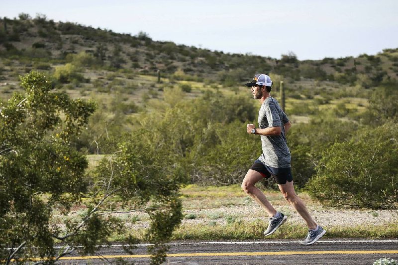 NASCAR driver Jimmie Johnson, shown here running April 6 in Avondale, Ariz., plans to compete in the Boston Marathon today.