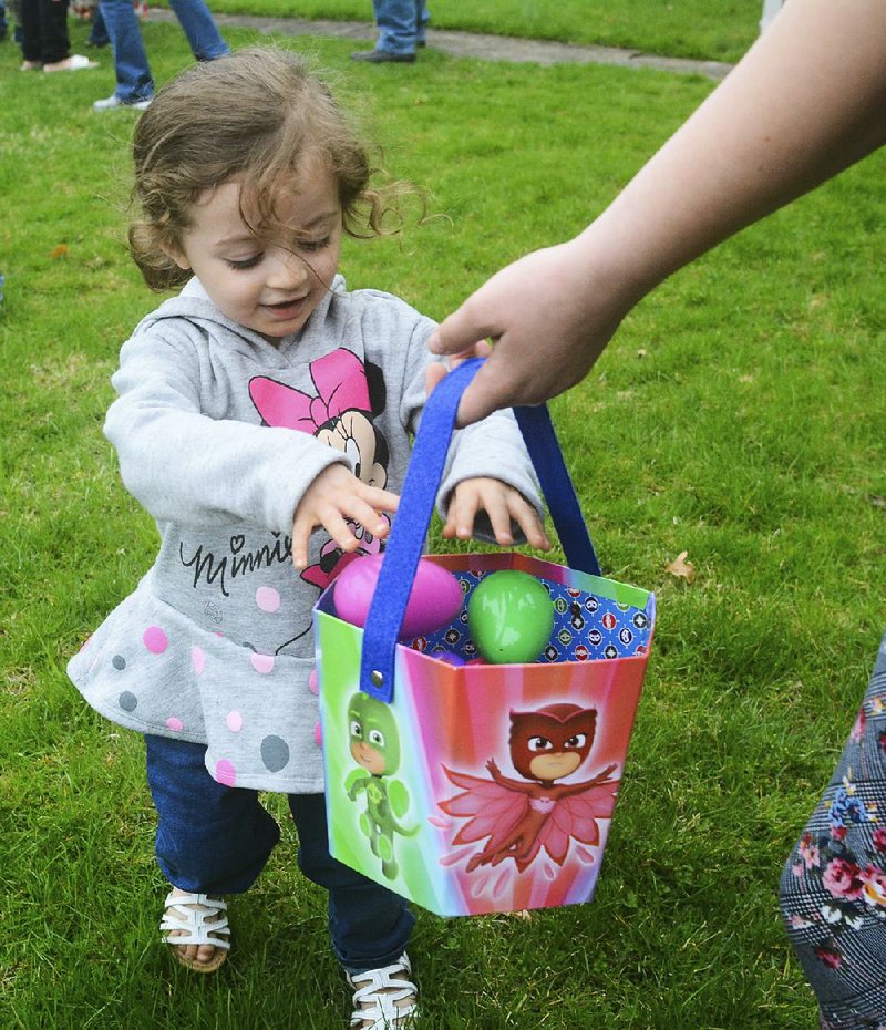Nova Ortiz, 3, places her eggs in a basket Sunday during an Easter egg hunt at Salem United Methodist Church in Orwigsburg, Pa. 