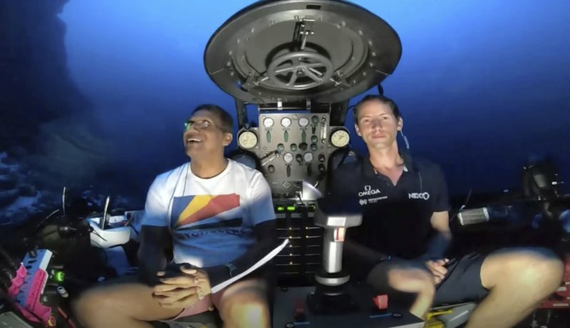 An image taken from video issued by Nekton shows Seychelles President Danny Faure, left, smiling after speaking from inside a submersible from the vessel Ocean Zephyr, under the water off the coast of Desroches, in the outer islands of Seychelles Sunday April 14, 2019. Faure toured the vessel and was presented with some of the findings and observations made by a British-led science expedition documenting changes taking place beneath the waves that could affect billions of people in the surrounding region over the coming decades (Nekton via AP)