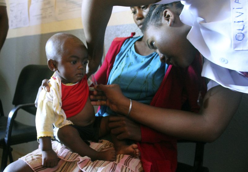 In this photo taken on Thursday, March 21, 2019, a volunteer nurse examines 6-moth-old Sarobidy, who is infected with measles, while her mother Nifaliana Razaijafisoa looks on, at a healthcare centre in Larintsena, Madagascar. As the island nation faces its largest measles outbreak in history and cases soar well beyond 115,000, the problem is not centered on whether to vaccinate children. Many parents would like to do so but face immense challenges including the lack of resources and information. (AP Photo/Laetitia Bezain)