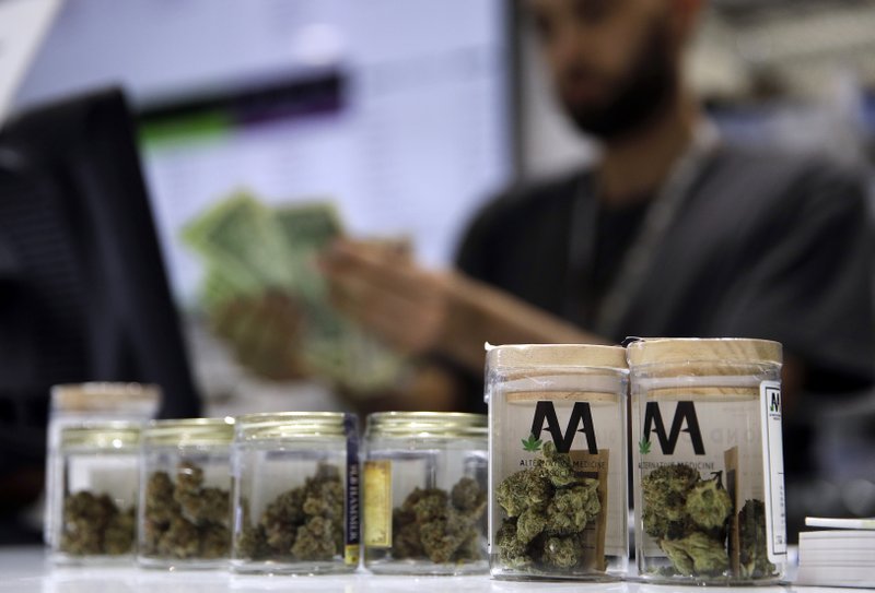 FILE - In this July 1, 2017, file photo, a cashier rings up a marijuana sale at the Essence cannabis dispensary in Las Vegas. Complaints that the state releases no information about who applies for and receives dispensary licenses in Nevada's booming retail marijuana business are spurring lawsuits and legislative proposals that appear poised to push the process public. (AP Photo/John Locher, File)