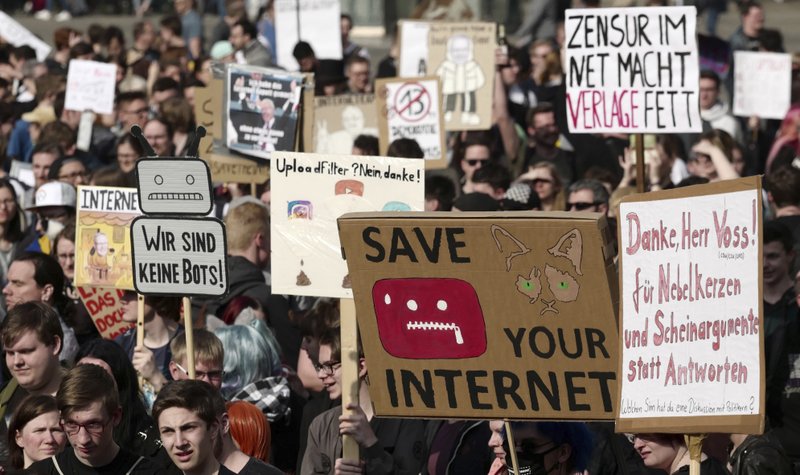 FILE - In this Saturday, March 23, 2019 file photo, people protest against the copyright bill, in Leipzig, Germany. The European Union approved on Monday April 15, 2019, a copyright law that aims to give more protection to artists and news organizations but which critics say will stifle freedom of speech and online creativity and punish smaller web companies. (Peter Endig/dpa via AP)

