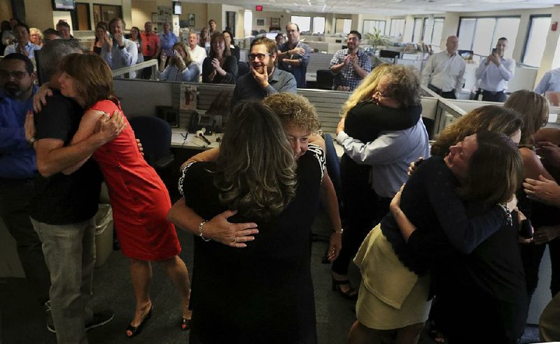 Staff of the South Florida Sun Sentinel celebrate their honor Monday, in Deerfield Beach, Fla., after winning the Pulitzer Prize for Public Service.