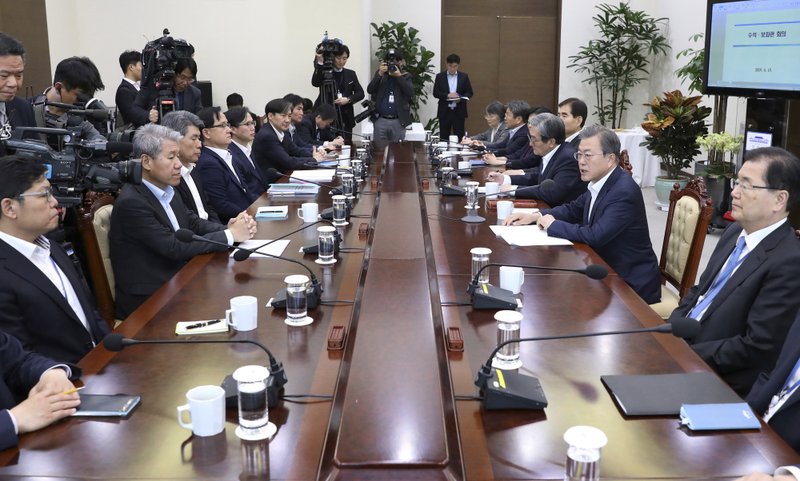 South Korean President Moon Jae-in, second from right, speaks during a meeting with his aids at the presidential Blue House in Seoul, South Korea, Monday, April 15, 2019. Moon says he's ready for a fourth summit with North Korean leader Kim Jong Un to help salvage faltering nuclear negotiations between Washington and Pyongyang. (Chun Shin/Newsis via AP)