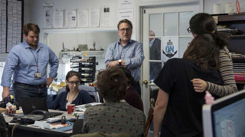 The Associated Press ROLLERCOASTER MOMENTS: Editor Rick Hutzell, center, gives a speech to his staff including Chase Cook, Nicki Catterlin, Rachael Pacella, Selene San Felice and Danielle Ohl at the Capital Gazette in Annapolis, Md., Monday. Hutzell said Monday that his staff experienced some "rollercoaster moments" as it won a special Pulitzer Prize citation for its coverage and courage in the face of a massacre in its own newsroom. "Clearly, there were a lot of mixed feelings," Hutzell told The Associated Press. "No one wants to win an award for something that kills five of your friends."