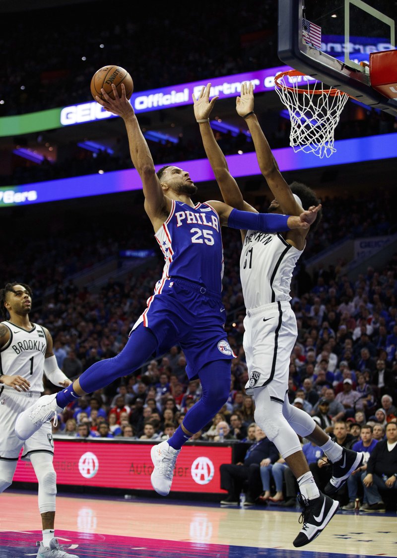 Philadelphia 76ers' Ben Simmons, left, of Australia, goes up for the shot against Brooklyn Nets' Jarrett Allen, right, during the first half in Game 2 of a first-round NBA basketball playoff series, Monday, April 15, 2019, in Philadelphia. (AP Photo/Chris Szagola)