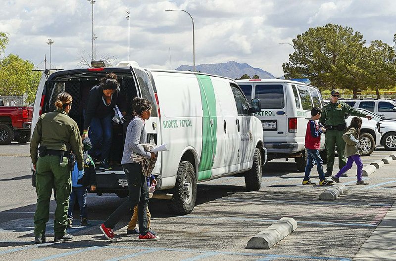 A Border Patrol van drops off migrants Saturday at a center in Las Cruces, N.M. 