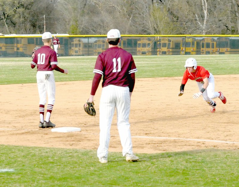 MARK HUMPHREY ENTERPRISE-LEADER Farmington junior Evan Shoffit dives headfirst into third base while Panther infielders await a throw during the Cardinals' 8-0 home victory over Siloam Springs on Monday, April 1.