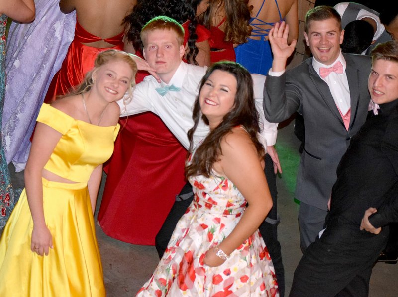 Westside Eagle Observer/MIKE ECKELS Makayla Case (left), Bryson Funk, Kaliey Sutherland, Zac Luker and Sam Philpott show off a few dance moves during the 2019 Decatur High School Prom at the Holland Farms main hall in Highfill April 12.