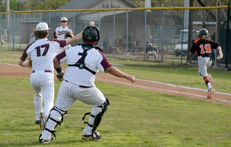 Graham Thomas/Herald-Leader Siloam Springs pitcher Taylor Pool throws the ball to first base as Gravette's Keegan Bulza runs down the baseline during Friday's game at James Butts Baseball Park in Siloam Springs.