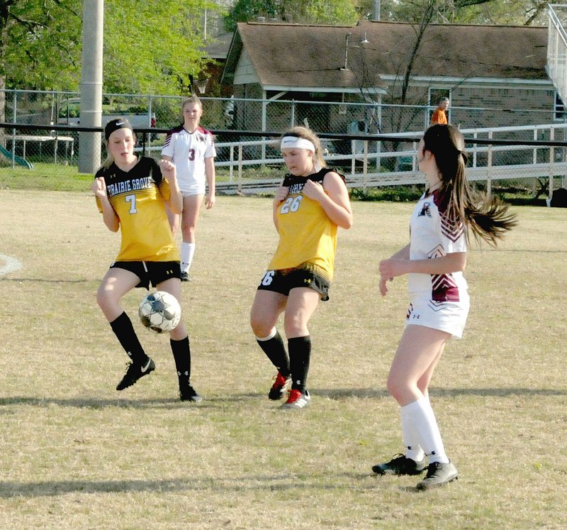 MARK HUMPHREY ENTERPRISE-LEADER/Prairie Grove teammates, Teagan Higgins (left) and Emily Maraver, work to move the ball downfield during the Lady Tigers run away 9-0 thrashing of Gentry at home on Tuesday, April 9.