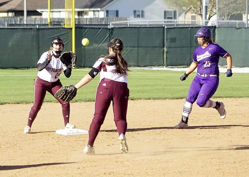 Westside Eagle Observer/RANDY MOLL Harley Stanfield fields the ball and tosses it to Meledy Owens at second to get a Berryville baserunner durng play between the two teams in Gentry on Thursday.