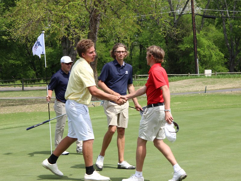 The Sentinel-Record/James Leigh WINNING COMBINATION: Henderson State sophomore Trey DePriest, right, congratulates Arkansas Tech's Andre Jacobs at the end of their round of golf at the Great American Conference championships as Southwestern Oklahoma State's Gustavo Tineo steps in. Jacobs was the individual winner, leading the Wonder Boys to their first conference title since 2013.