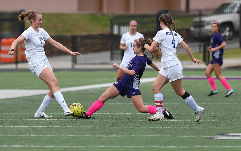 NWA Democrat-Gazette/J.T. WAMPLER Fayetteville's Ashlynn Robinson tries to get past Rogers' Ashlynn Robinson (LEFT) and Haley Arrick Tuesday April 16, 2019 at Harmon Field in Fayetteville. Rogers won 3-1 in a shoot-out after a 1-1 tie in regulation.