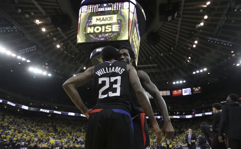 Los Angeles Clippers guard Lou Williams (23) celebrates with Patrick Beverley during the second half of Game 2 of a first-round NBA basketball playoff series against the Golden State Warriors in Oakland, Calif., Monday, April 15, 2019. (AP Photo/Jeff Chiu)