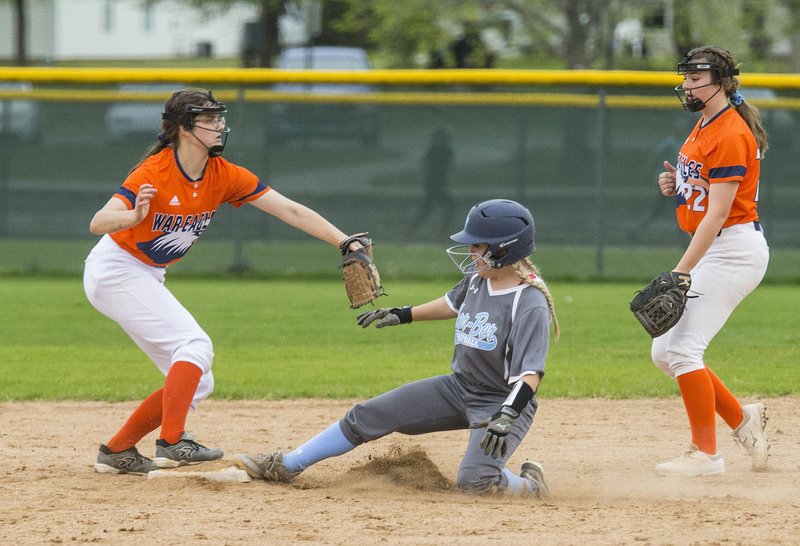 NWA Democrat-Gazette/BEN GOFF @NWABENGOFF Gabbie Smith, Springdale Har-Ber catcher, slides in at second after being tagged out by Jo Patten (left), Rogers Heritage shortstop, after the ball was fielded by Sydney Price, Rogers Heritage second baseman, in the sixth inning Tuesday, April 16, 2019, at Veterans Park in Rogers.