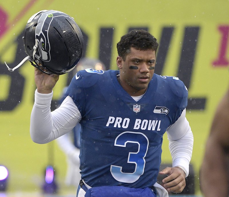  In this Jan. 27, 2019, file photo, NFC quarterback Russell Wilson of the Seattle Seahawks runs onto the field during player introductions before the NFL Pro Bowl football game against the AFC in Orlando, Fla. (AP Photo/Phelan M. Ebenhack, File)