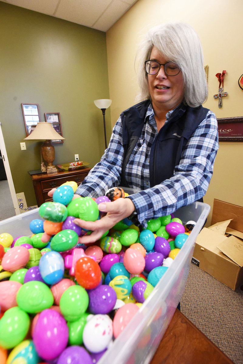 Tami Stewart, church administrator at Central United Methodist Church in Rogers, shows Tuesday, April 16, 2019, some of the 8,000 plastic eggs that will be set out on church grounds for a community Easter egg hunt at 3 p.m. Saturday. Church volunteers filled the eggs with candy and prizes, and some were purchased already assembled, Stewart said. The hunt will be featured north of the church building at 26th Street and New Hope Road. Everyone is welcome. NWA Democrat-Gazette/FLIP PUTTHOFF