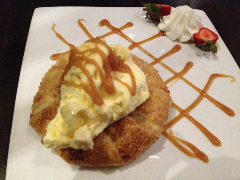 The Apple Galette at 42 Bar and Table comes with a healthy dollop of vanilla ice cream and swirls of caramel sauce. Arkansas Democrat-Gazette/Jennifer Nixon