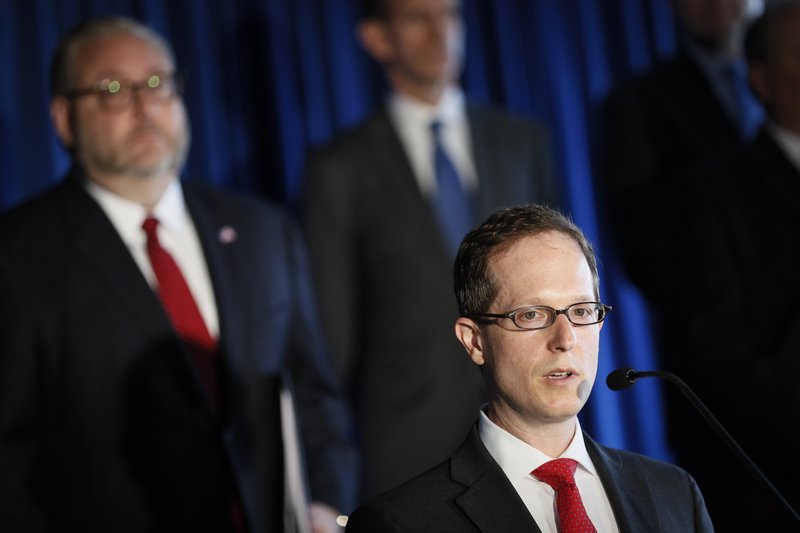 U.S. Attorney Benjamin C. Glassman, of the Southern District of Ohio, speaks beside members of Appalachian Regional Prescription Opioid Strike Force, during a news conference, Wednesday, April 17, 2019, in Cincinnati. Federal authorities say they have charged 60 people, including 31 doctors, for their roles in illegal prescribing and distributing of opioids and other dangerous drugs. (AP Photo/John Minchillo)