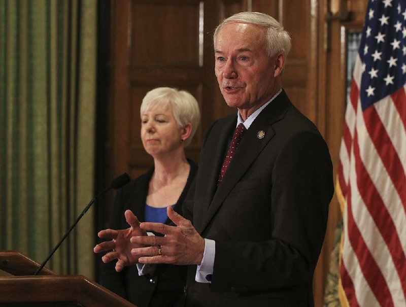 Gov. Asa Hutchinson (right) is shown in this file photo with DHS Director Cindy Gillespie. 