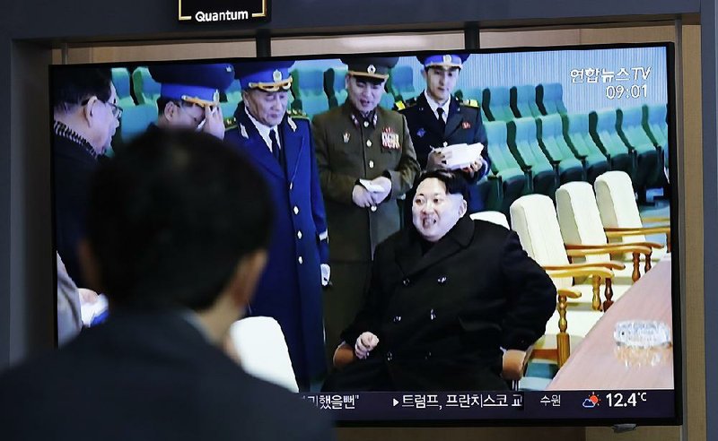 A passer-by at the railway station in Seoul, South Korea, watches a news report today on North Korean leader Kim Jong Un at a test-firing of a new tactical guided weapon. 