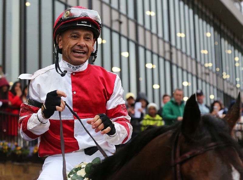 Jockey Mike E. Smith celebrates after Omaha Beach won the Arkansas Derby on Saturday, April 13, 2019, at Oaklawn Park in Hot Springs. 
