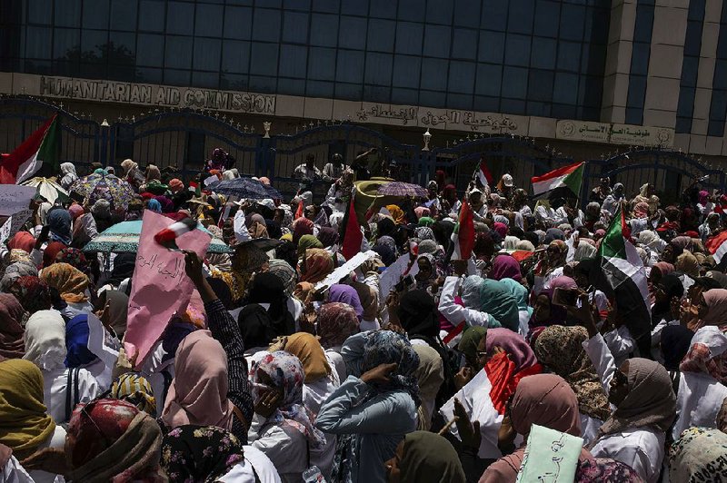 Protesters from the Sudanese medical profession syndicate  march  toward a sit-in Wednesday in the Armed Forces Square in Khartoum, Sudan. 