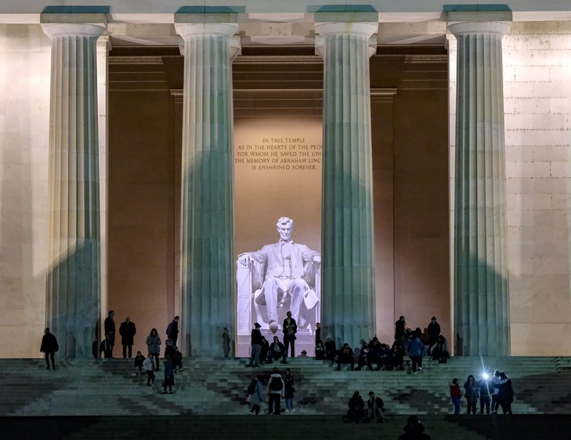 Visitors gather at the Lincoln Memorial at dusk. The setting sun (and fewer crowds) make this a perfect time to visit the popular site. Photo by Bonnie Jo Mount via The Washington Post