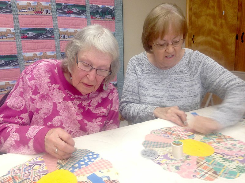 Sally Carroll/McDonald County Press Bunker Hill Quilting Club members Dora Latty and Donna Hobbs work on a quilt together.