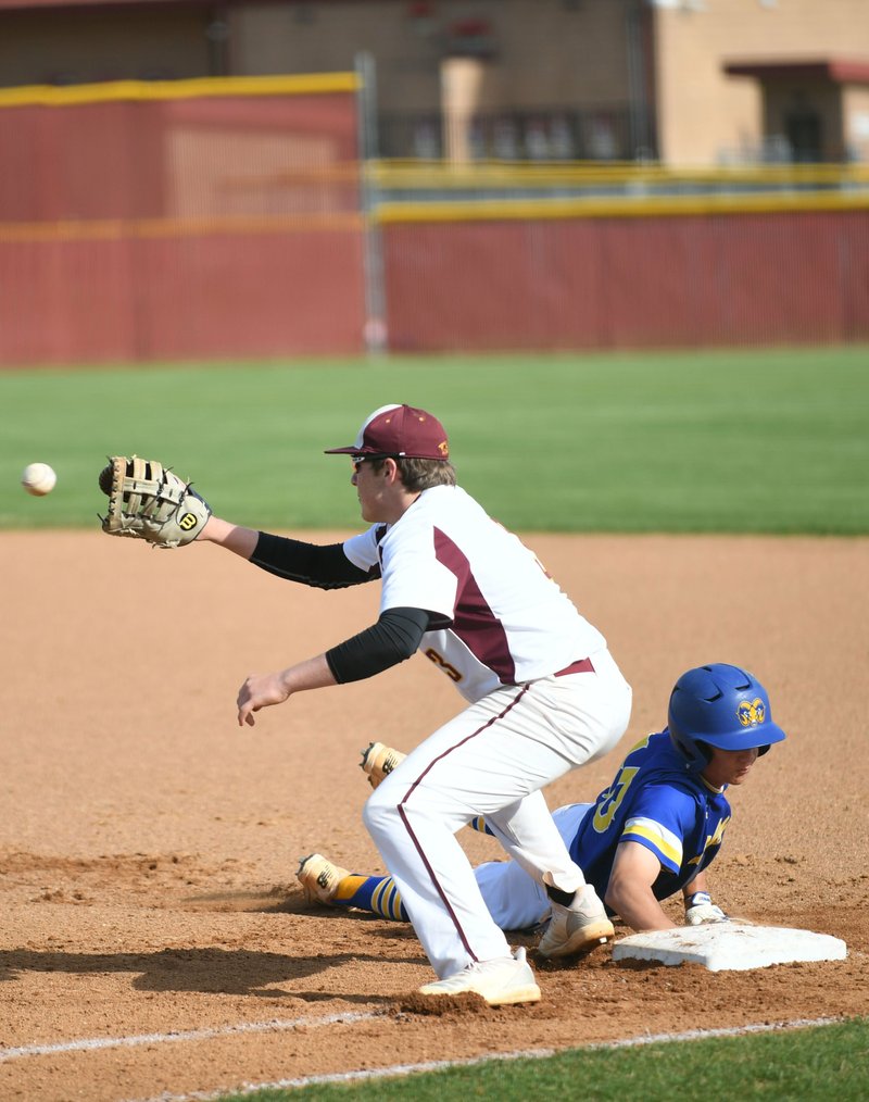 The Sentinel-Record/Grace Brown BEAT THE THROW: Lake Hamilton junior Cade Payton (3) goes for the catch as Lakeside junior Brady Prince (10) dives back to first during Tuesday's game at Lake Hamilton.