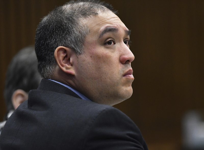 In this April 10, 2019, file photo, former Michigan state trooper Mark Bessner listens to Assistant Wayne County Prosecutor Matthew Penney deliver his opening argument in Bessner's trial, in Detroit. Charged with second-degree murder, Bessner was convicted of involuntary manslaughter Wednesday, April 17, 2019, in the death of Detroit teenager, Damon Grimes, who crashed an all-terrain vehicle and died when he was shot with a Taser by Bessner in 2017. (Clarence Tabb Jr./Detroit News via AP)