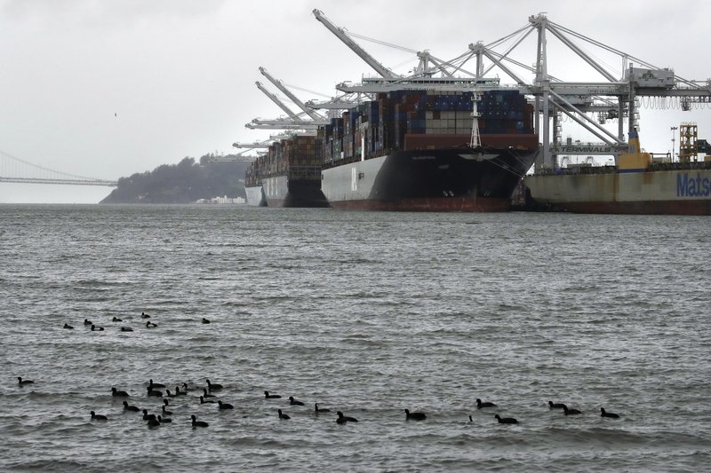  In this March 6, 2019, file photo, container ships docked at the Port of Oakland wait to be unloaded in Oakland, Calif. On Wednesday, April 17, the Commerce Department reports on the U.S. trade gap for February. (AP Photo/Ben Margot, File)